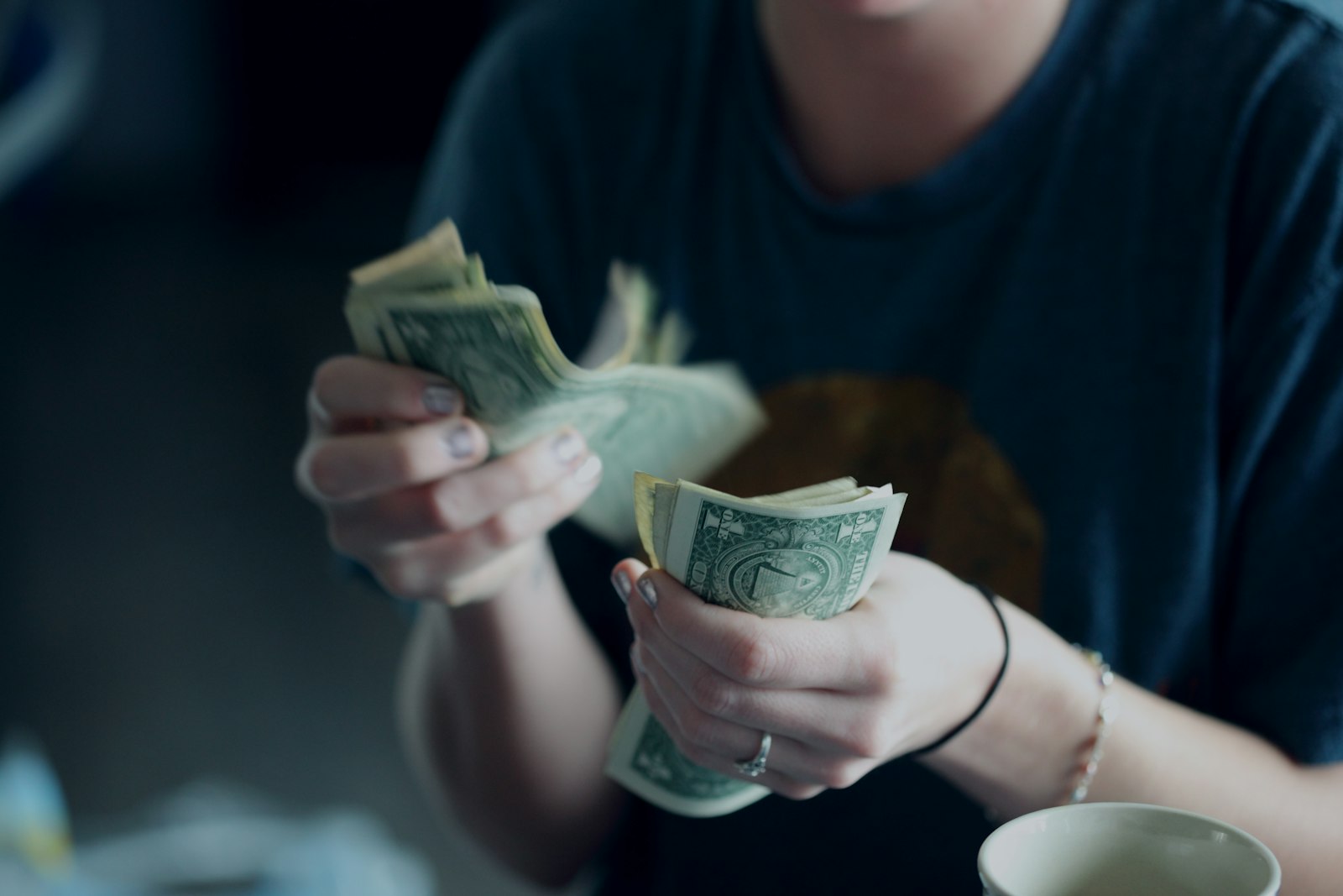 A person counting cash to pay down a tax balance