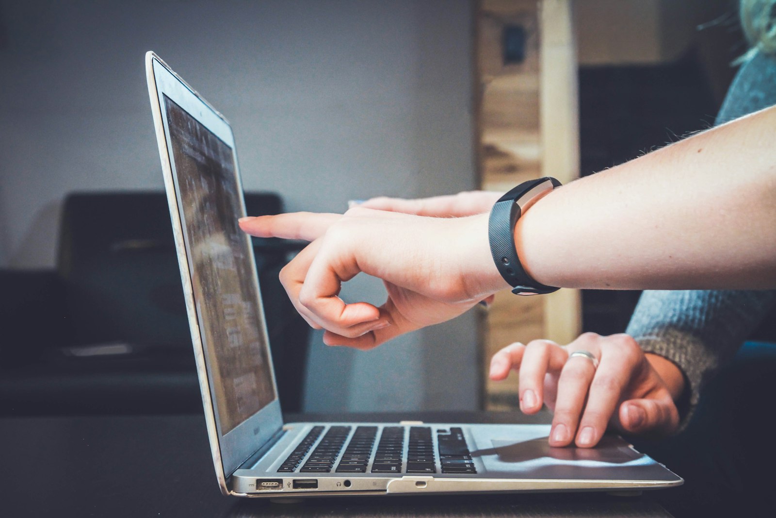Two people reviewing accounting software on a laptop