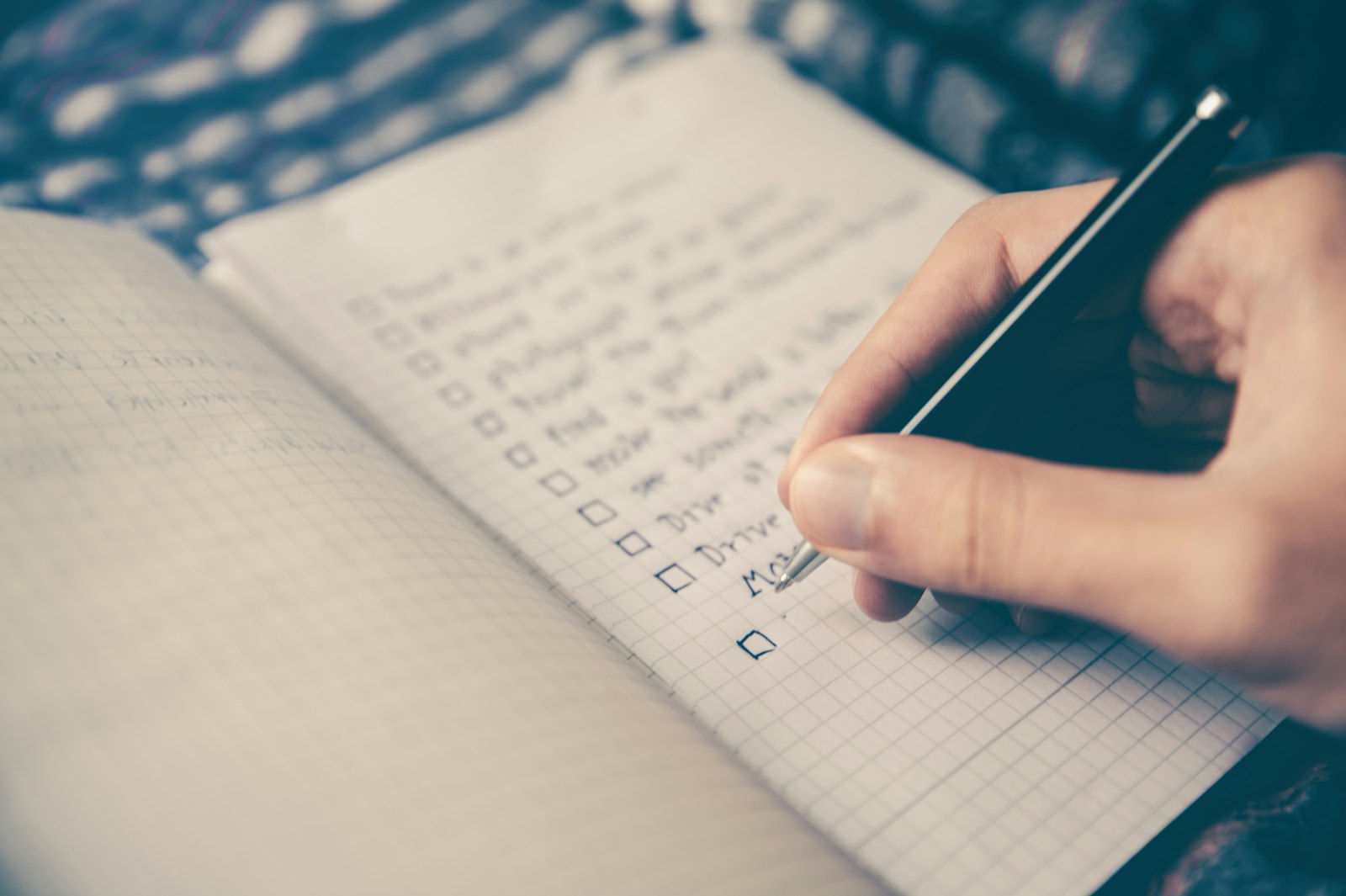 A handwritten checklist in a notebook